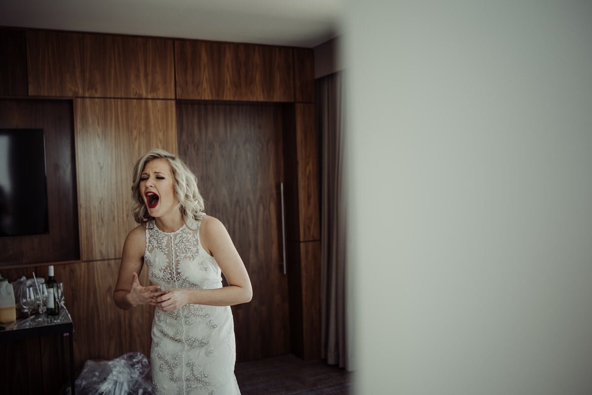 bride laughing dramatic while getting ready