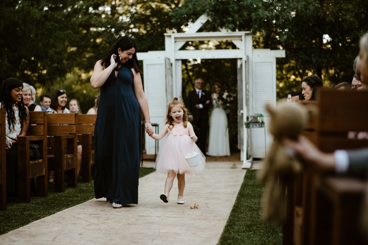 flower girl excited walking down the aisle