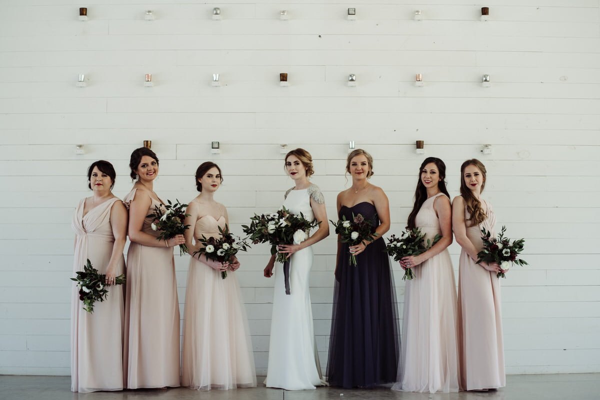 bridesmaids against white modern backdrop