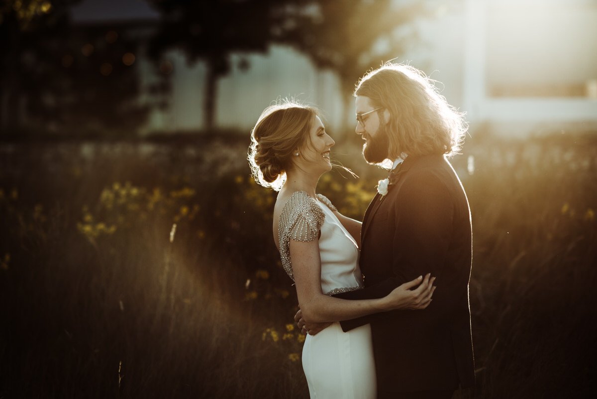 bride and groom portrait with beautiful sun flare