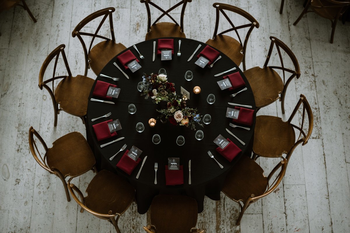 dark and romantic table display at wedding