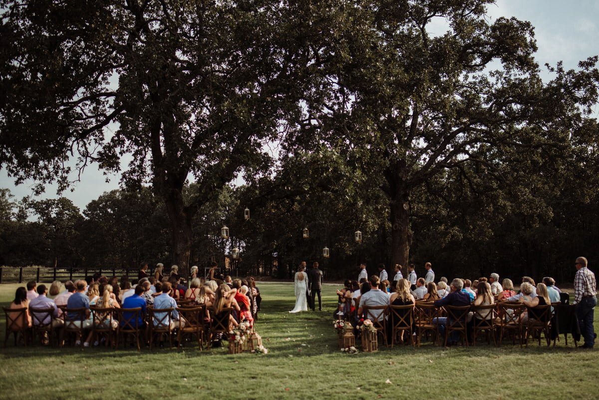 wide display of ceremony with large trees