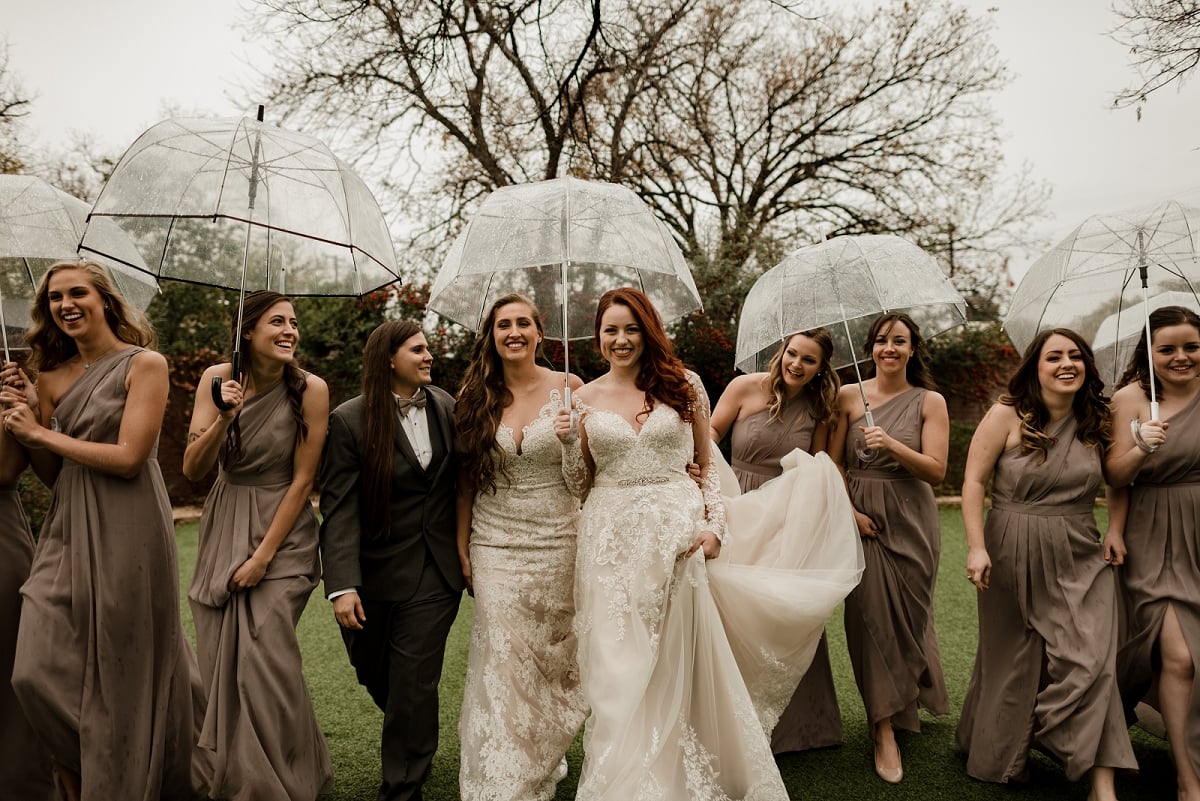 bridal party walks through rain