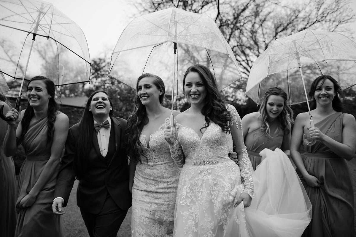bridal party walks through rain