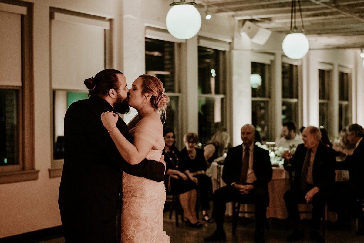 wedding couple kisses at reception