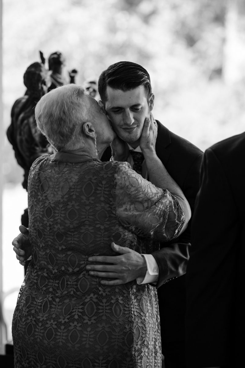 grandmother kisses groom