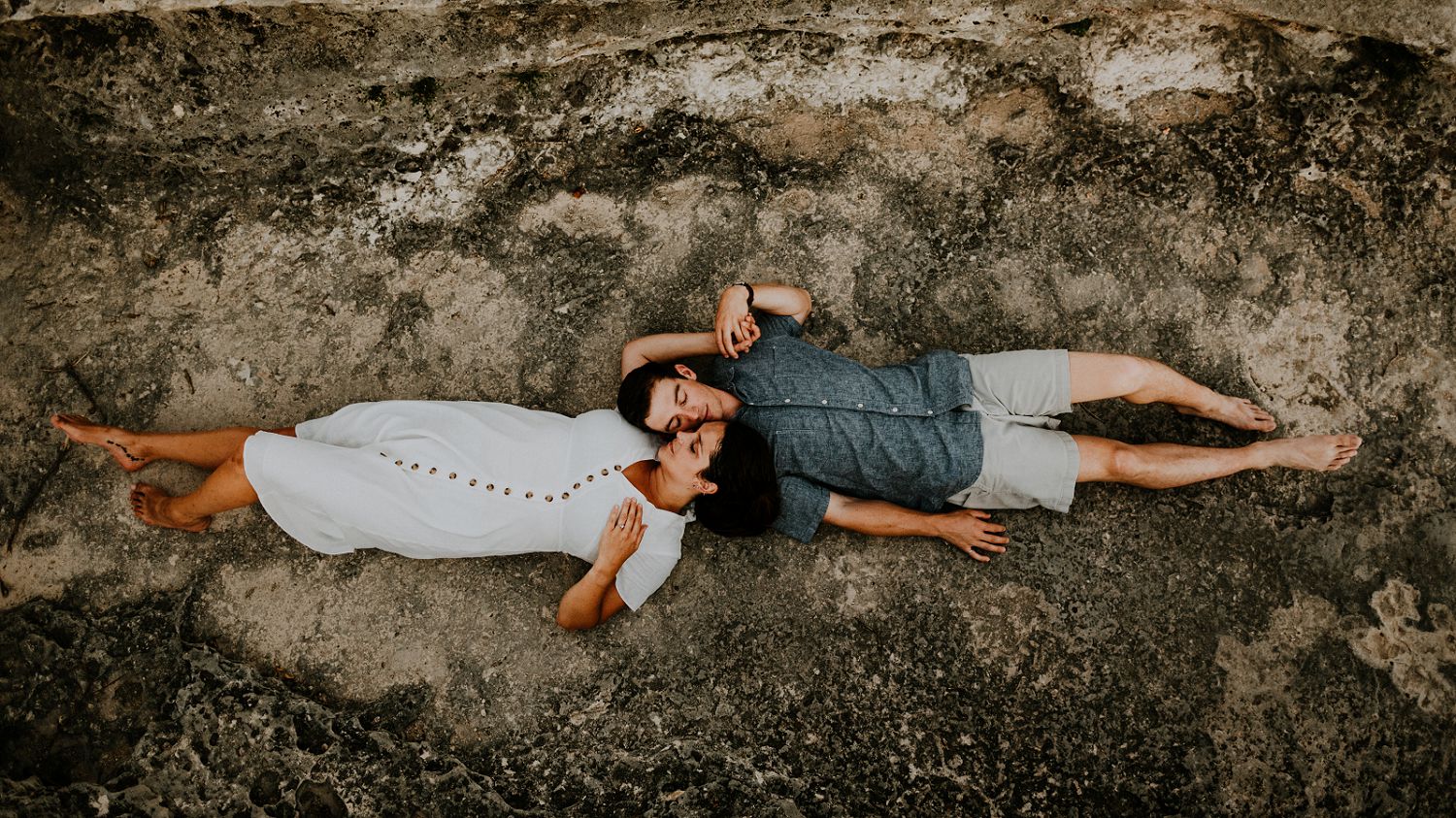 couple laying down on rocks