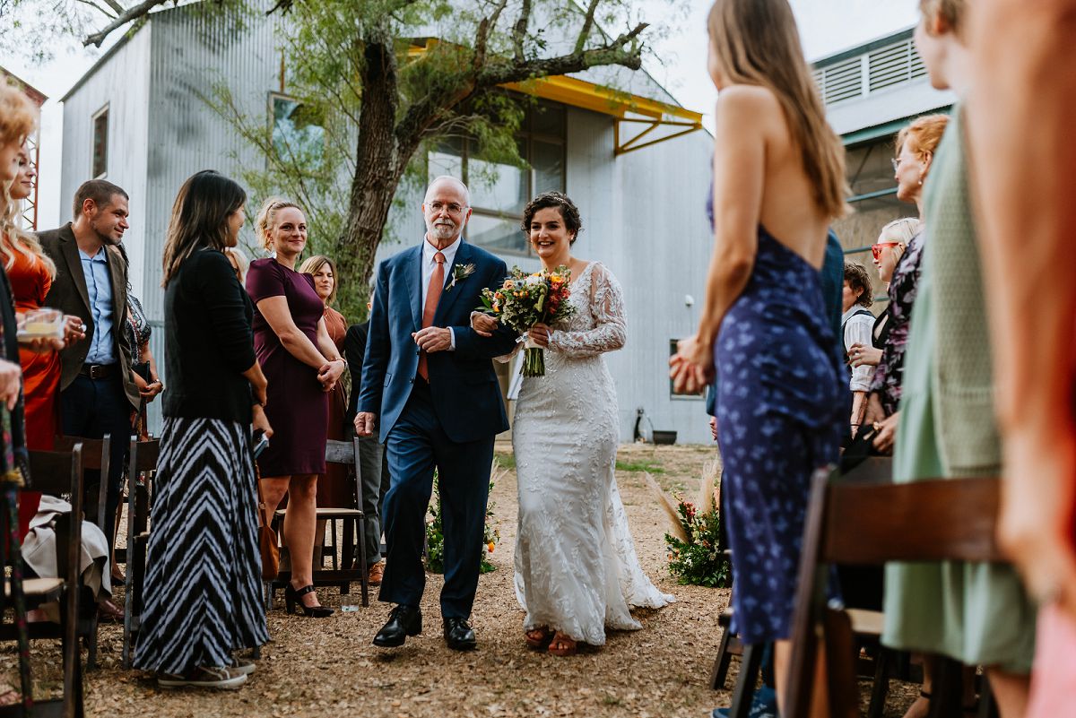 bride walking down center aisle with father for ceremony