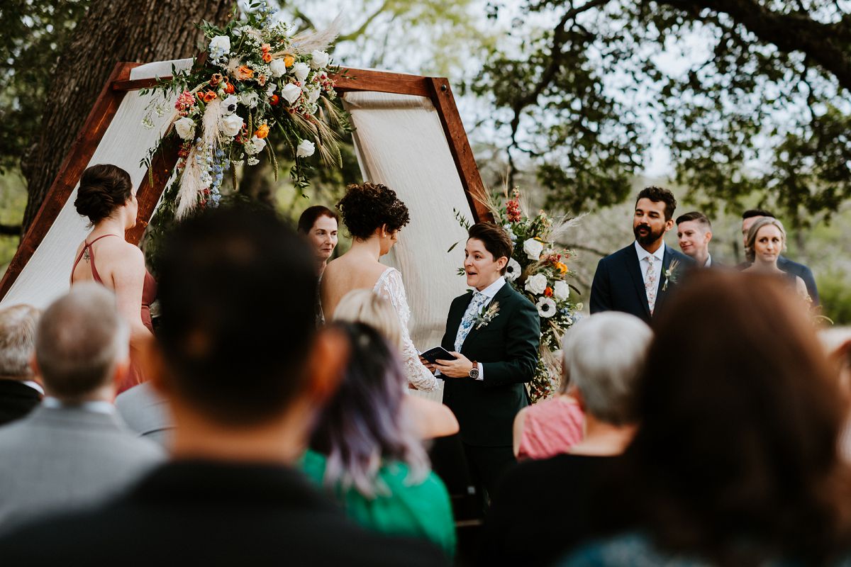 brides giving each other toasts with paper in hand