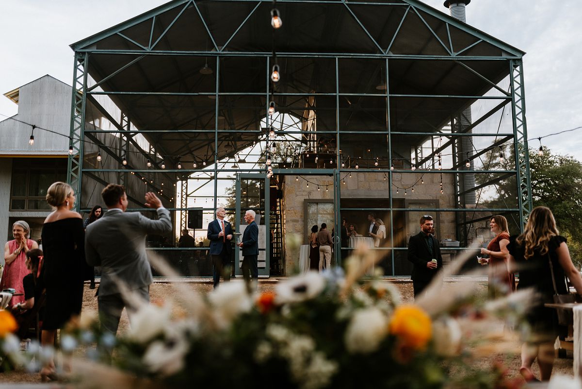 wide photo of guests hanging out with venue displayed