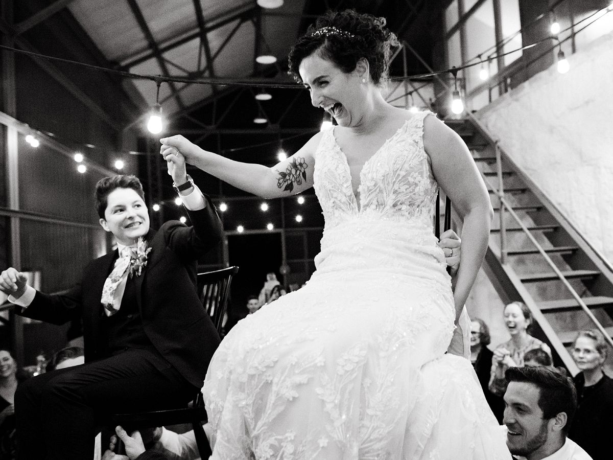 brides laughing intensely for Hora at wedding