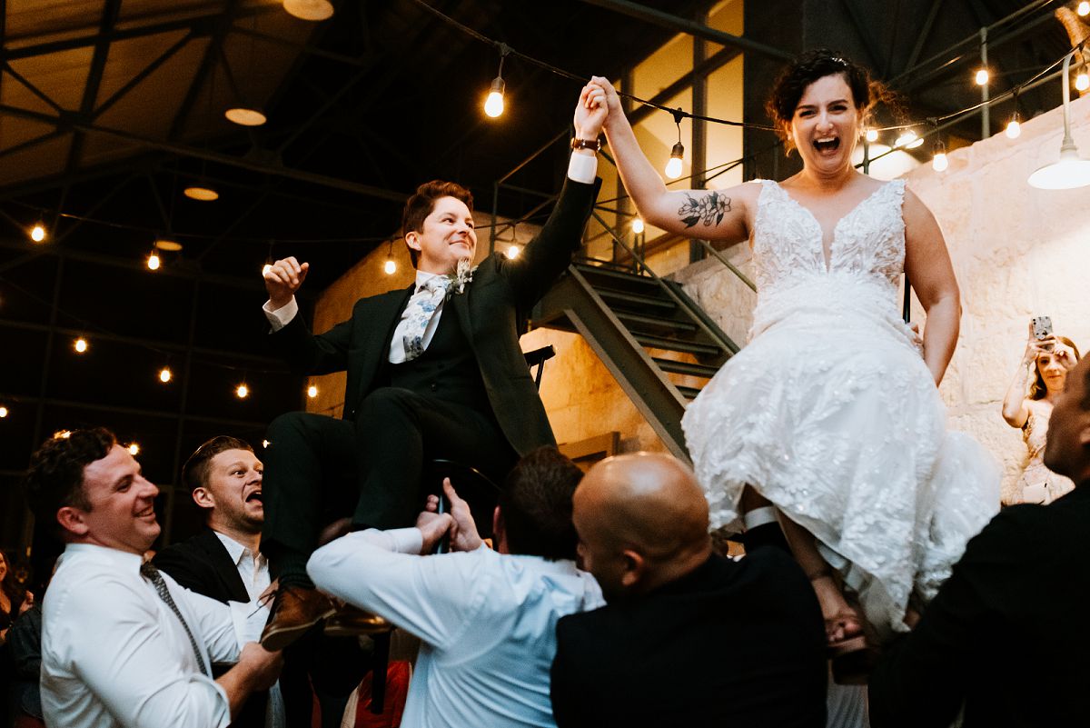 brides laughing intensely for Hora at wedding