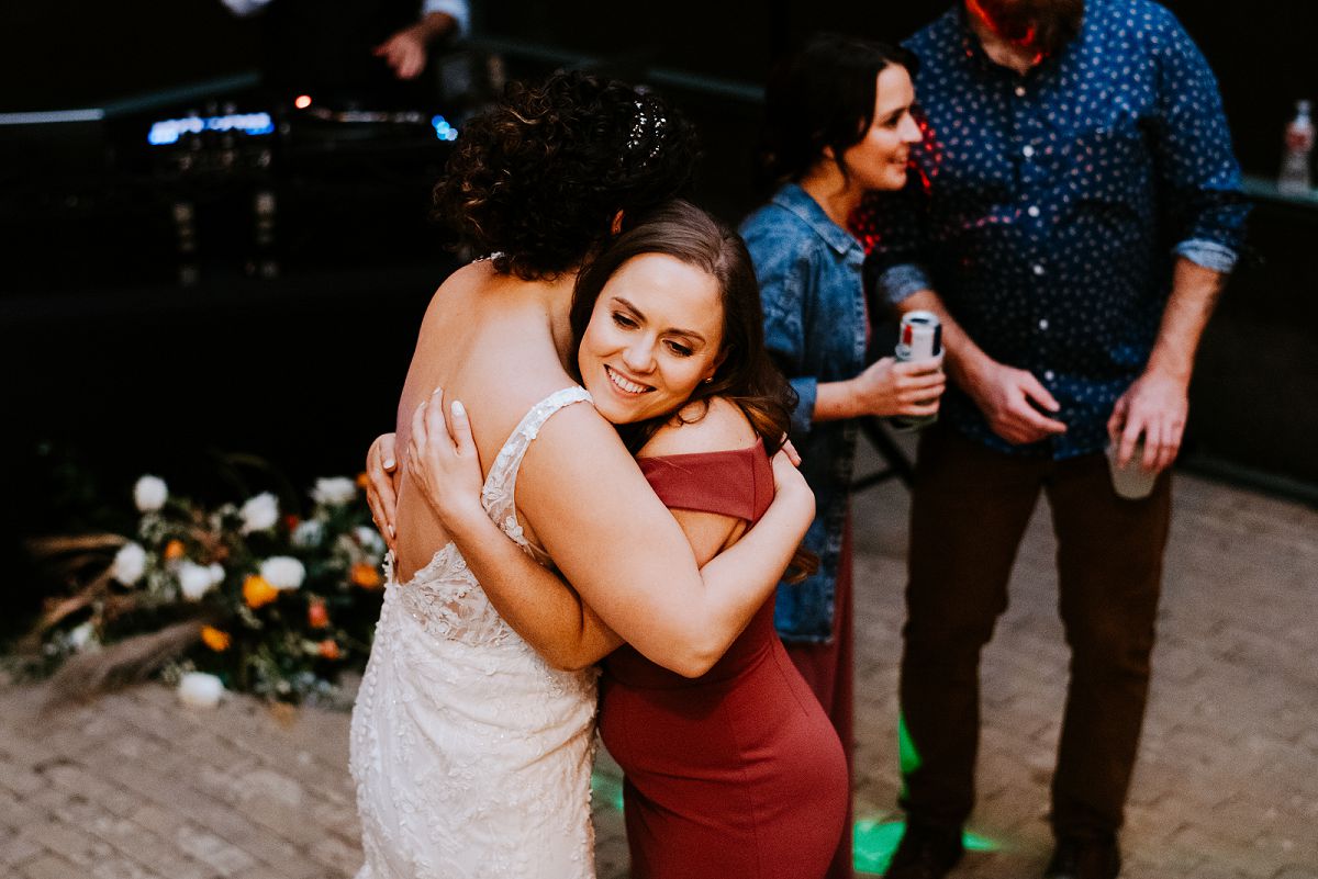 woman giving bride a hug