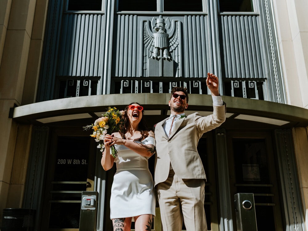 couple celebrating on courthouse steps