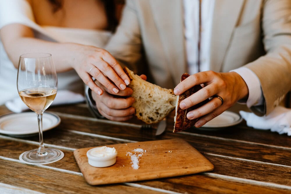 couple breaking bread at restaurant