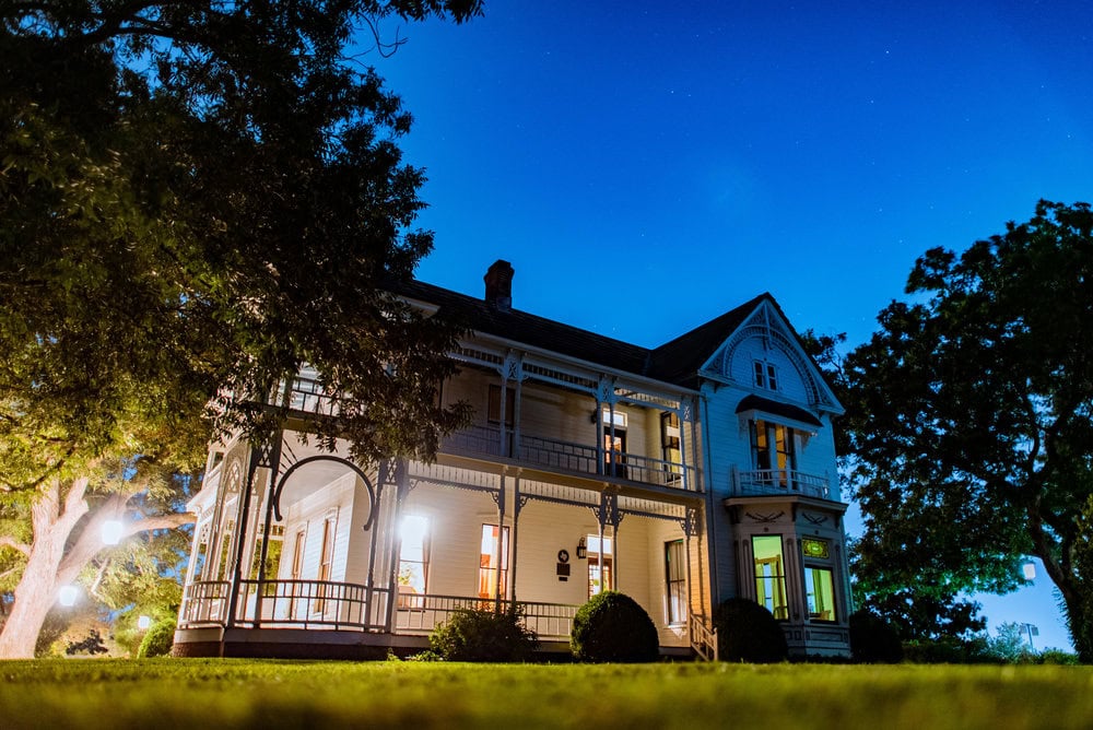 vibrant wide night photo in front of historic wedding venue showing stars at night