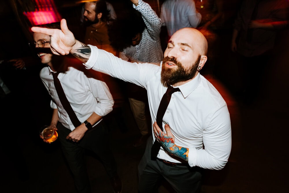 direct flash photo of guests dancing during wedding reception