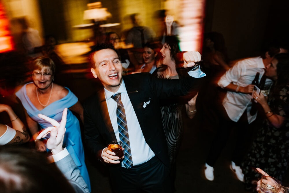direct flash photo of guests dancing during wedding reception