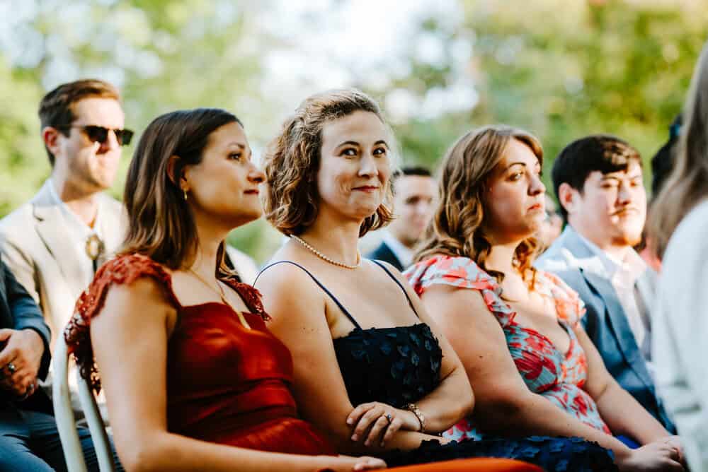 wedding guest looks at camera during ceremony