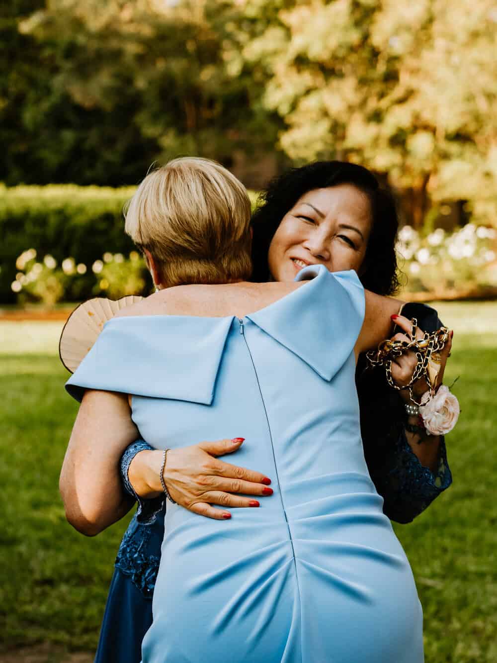 couples mother hugging after wedding ceremony