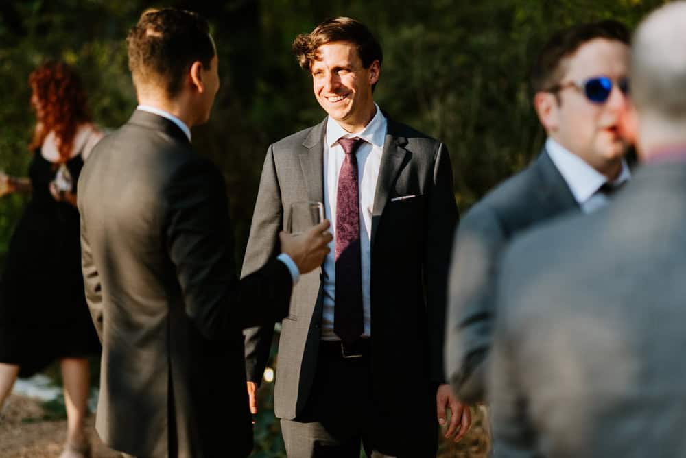 wedding guests hanging out at golden hour cocktail hour outdoors
