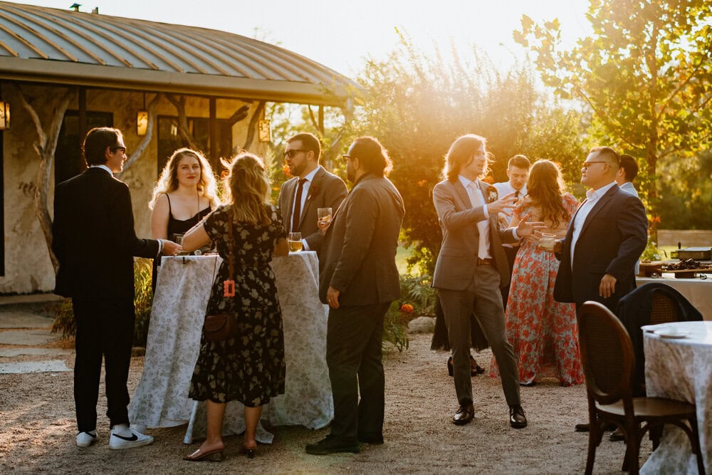 wedding guests hanging out at golden hour cocktail hour outdoors
