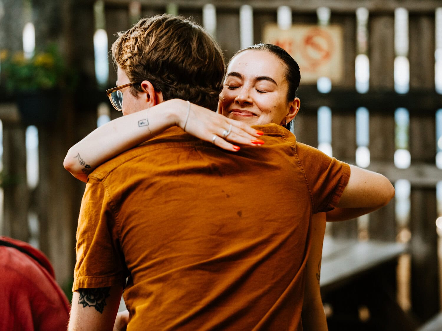 woman hugging man as they welcome each other for small wedding