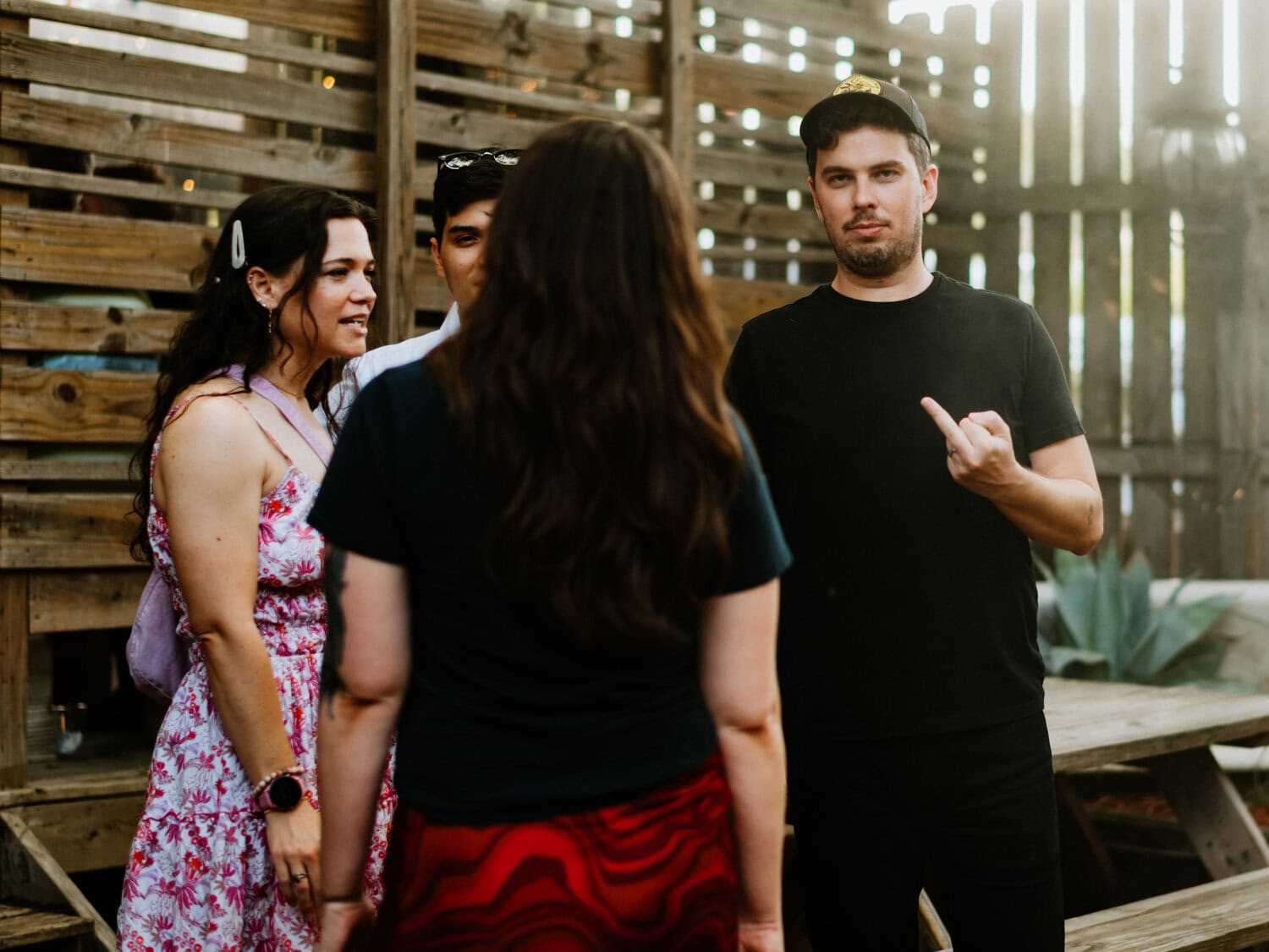 groom flicking off the photographer while looking directly into camera