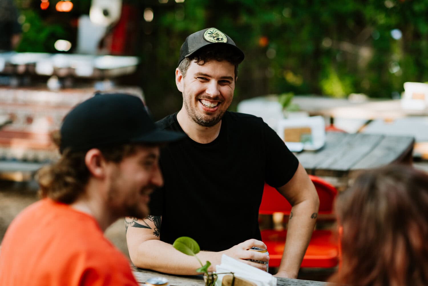 groom sitting down smiling towards friend 