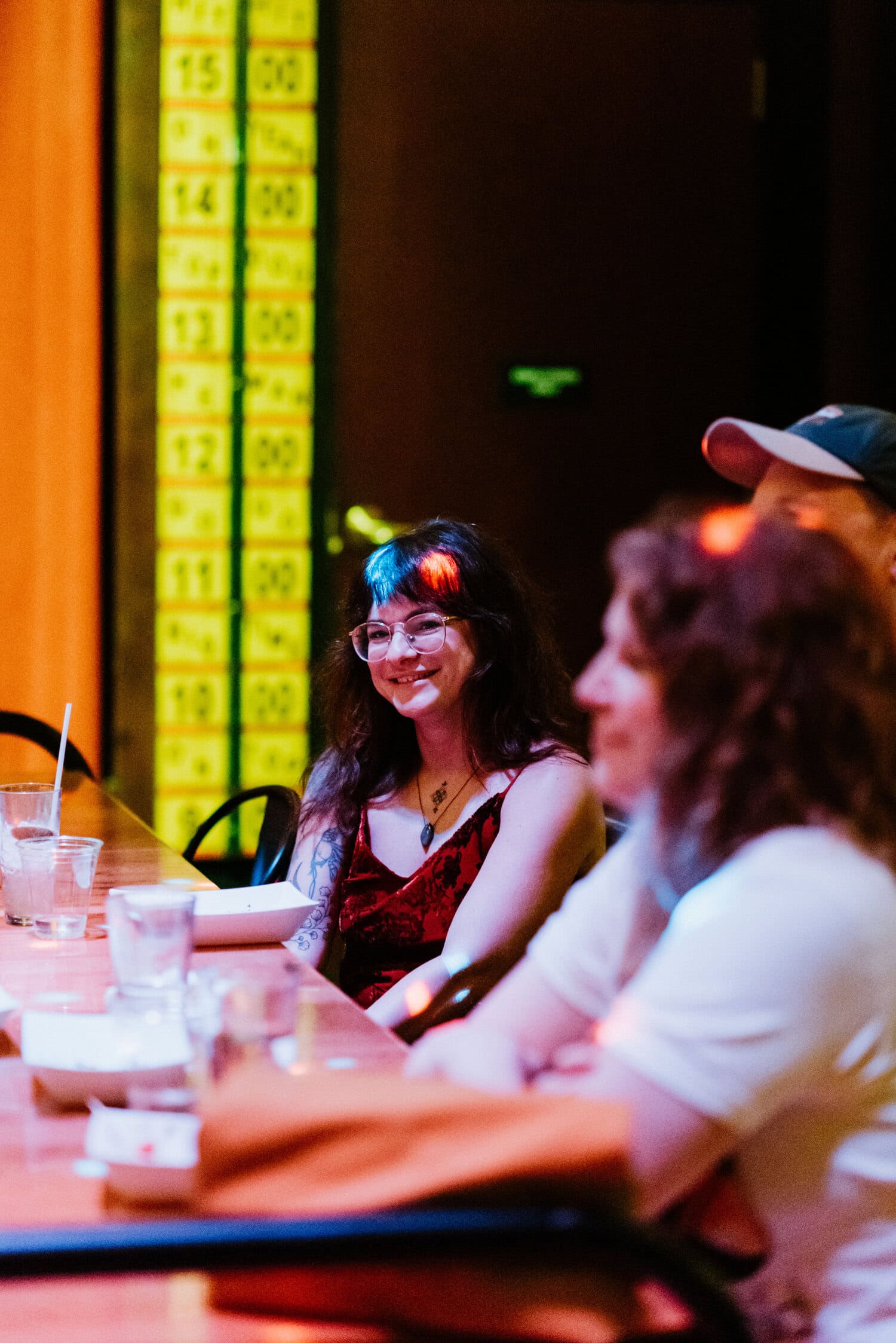 friends of couple sitting inside dark room of Barrel O' Fun for reception