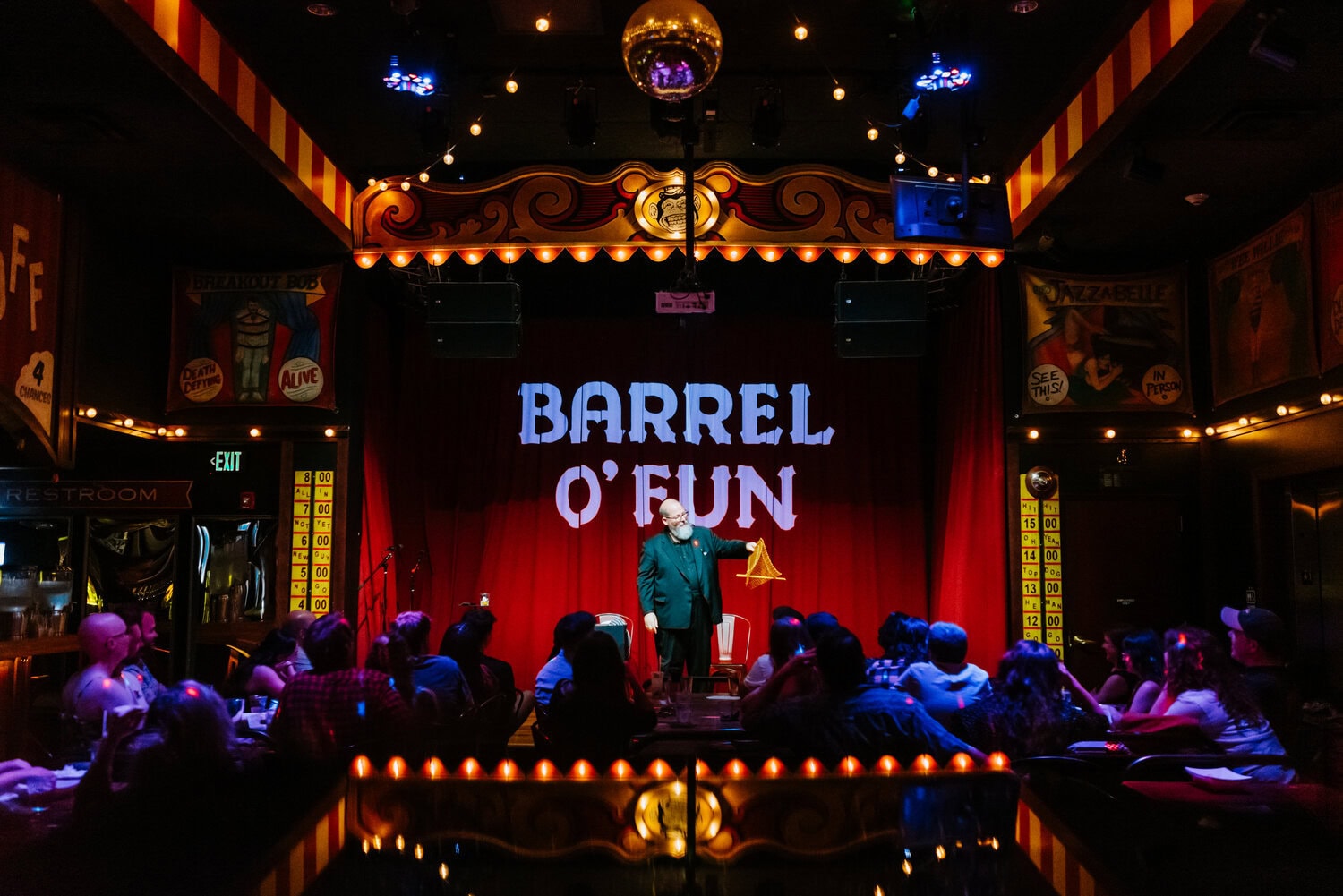 Brad Henderson performing magician act on stage at Barrel O' Fun 