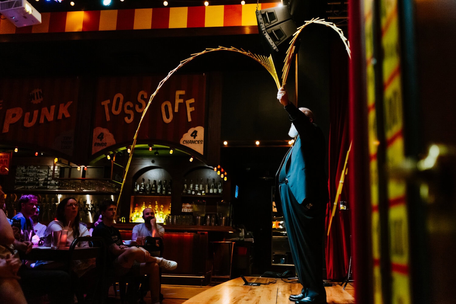 Brad Henderson performing magician act on stage at Barrel O' Fun 