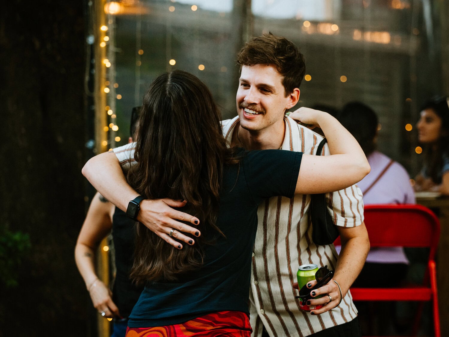 people hugging outdoors as they welcome each other for casual reception