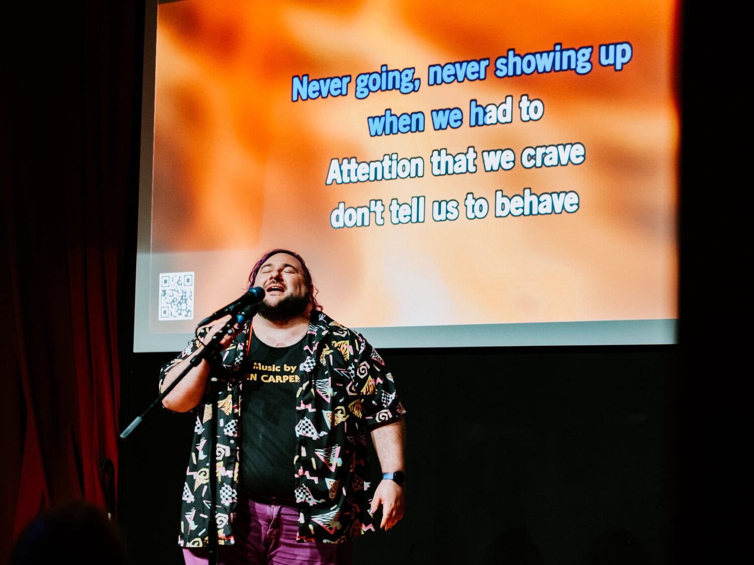 friends singing karaoke on stage at barrel o' fun during wedding reception